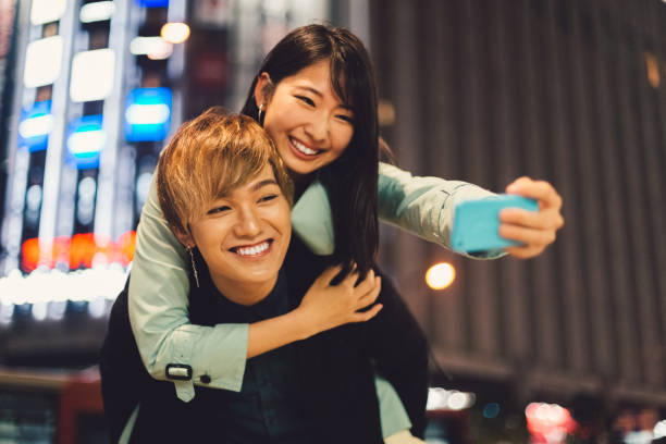 istock Couple in Asia taking selfie on piggyback 953466792