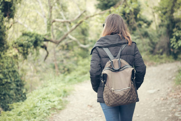 Rear view of young woman walking at nature