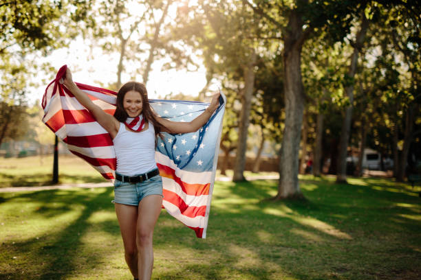 istock Girl waving American flag 953467244
