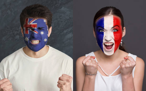 istock Emotional soccer fans with painted flags on faces 953470302
