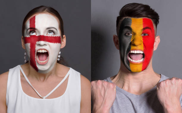 istock Emotional soccer fans with painted flags on faces 953470320