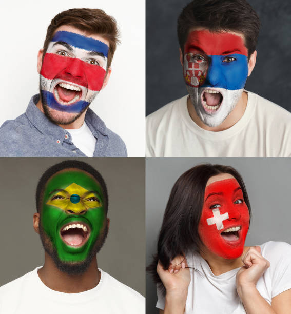istock Emotional soccer fans with painted flags on faces 953470520