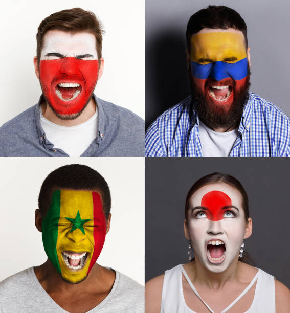 istock Emotional soccer fans with painted flags on faces 953470542