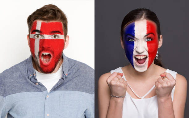 istock Emotional soccer fans with painted flags on faces 953470560