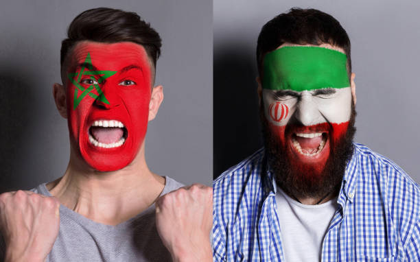 istock Emotional soccer fans with painted flags on faces 953470680