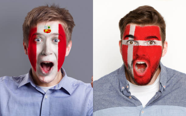 istock Emotional soccer fans with painted flags on faces 953471502