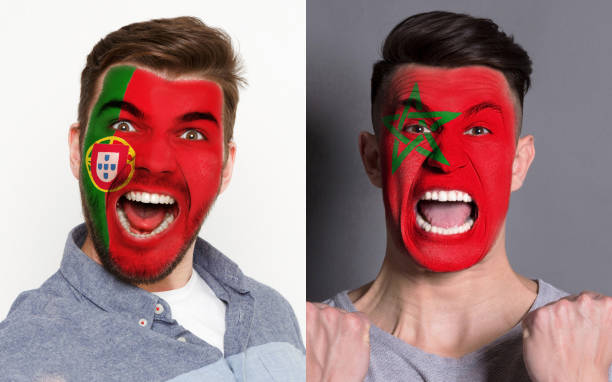 istock Emotional soccer fans with painted flags on faces 953472004