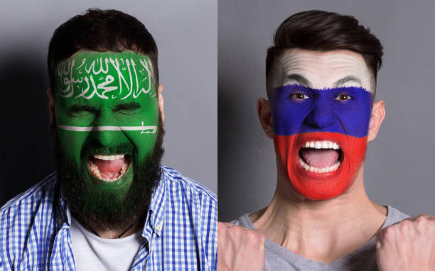 istock Emotional soccer fans with painted flags on faces 953472026
