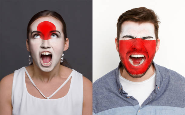 istock Emotional soccer fans with painted flags on faces 953472400