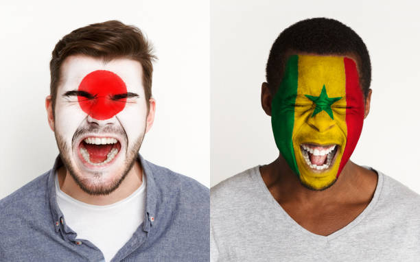 istock Emotional soccer fans with painted flags on faces 953472418