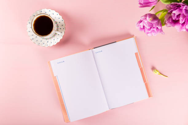 istock Open Notebook for writing Dreams and Ideas with flowers nearby 953472888