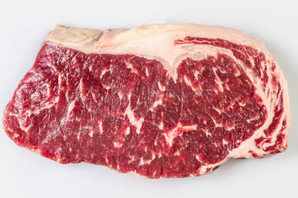 istock Ripened seasoned beef rump or striploin steak on white background isolated. Top view. 953476156