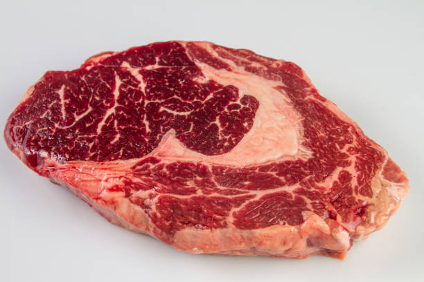 istock Ripened seasoned beef rib eye or entrecote steak on white background isolated 953476164