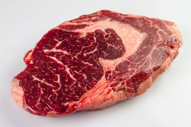 istock Ripened seasoned beef rib eye or entrecote steak on white background isolated 953476176