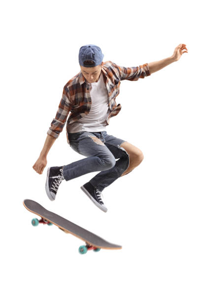 Teenage skater boy jumping Teenage skater boy jumping isolated on white background jump board stock pictures, royalty-free photos & images