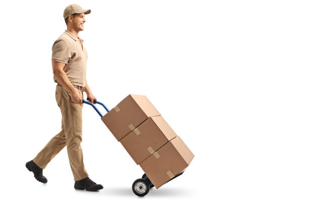 istock Delivery guy pushing a hand truck with boxes 953478554