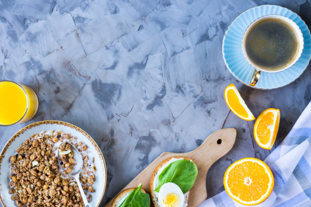 istock Healthy hearty breakfast - muesli, sandwich with egg, coffee, orange and juice. Copyspace 953479882