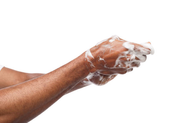 istock Black man washing hands isolated on white background 953482558
