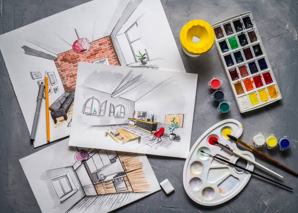 istock Creative profession: designer's desk with scattered sketches, paints, brushes, liner, pencil. 953496858