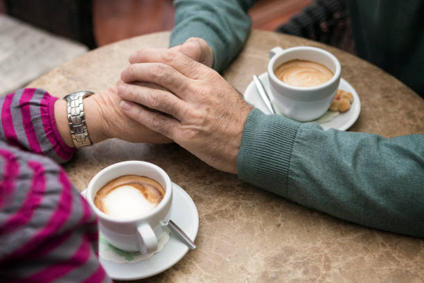 istock Senior couple holding hand during morning coffee 953496908