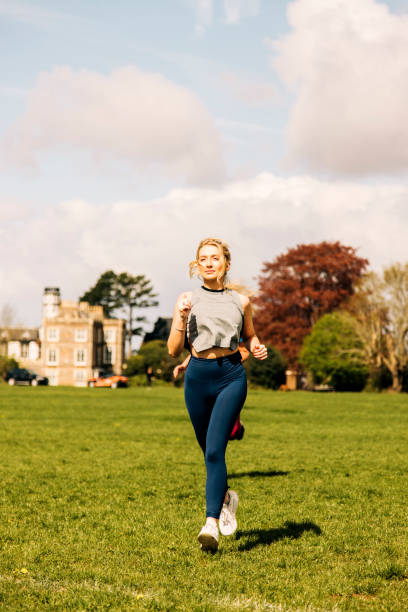 Girl running in the park A girl running in a park in Bristol, UK 11904 stock pictures, royalty-free photos & images