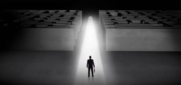 istock Businessman going straight ahead between two mazes 953502560