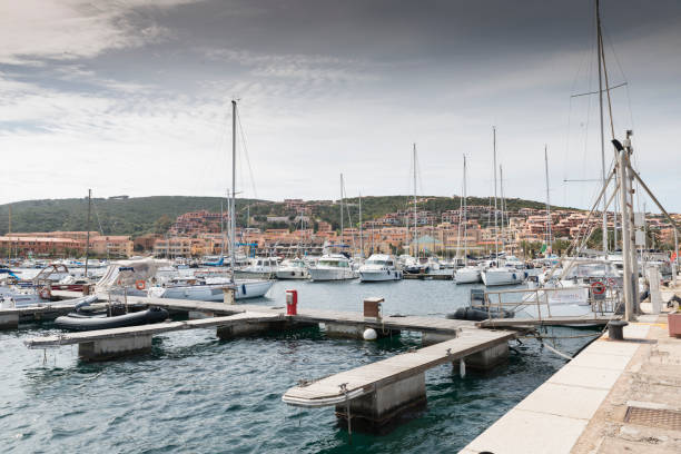 Boats in Alghero harbor on a clear summer day. Sardinia, Italy