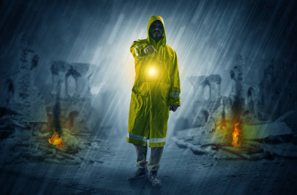 istock Man with a glowing lantern at a catastrophe scene 953509992