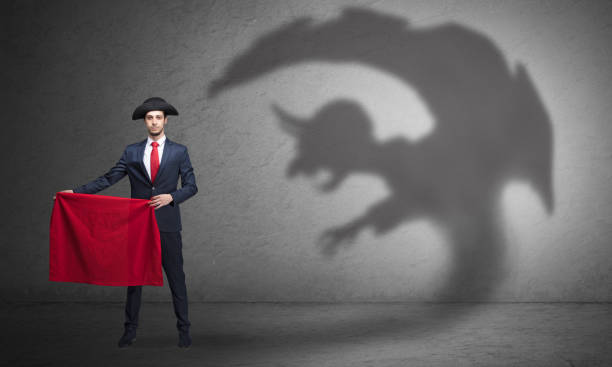istock Businessman with imp shadow and toreador concept 953510248
