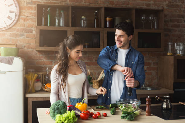 istock Happy couple cooking dinner together 953511512