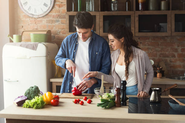 istock Happy couple cooking dinner together 953511618
