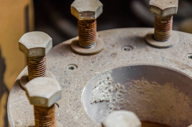 istock Old rusty bolts in the dust on the pipe joint 953511684