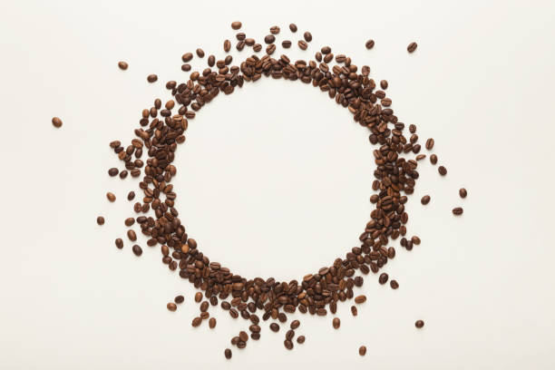 istock Circle made of coffee seeds on white isolated background 953511924