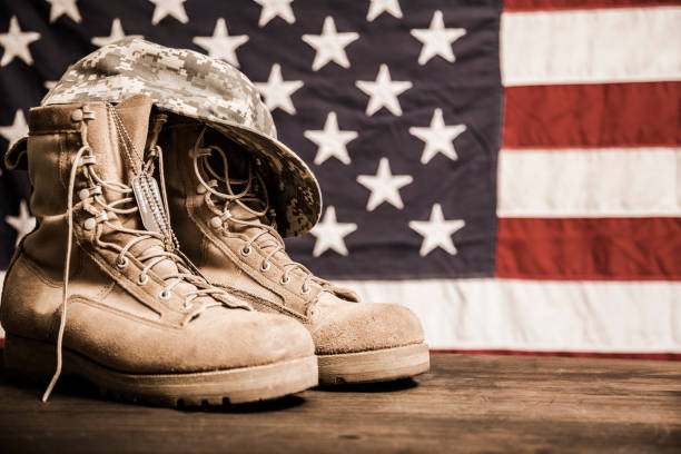 istock USA Military boots, hat and dog tags with flag. 953512520