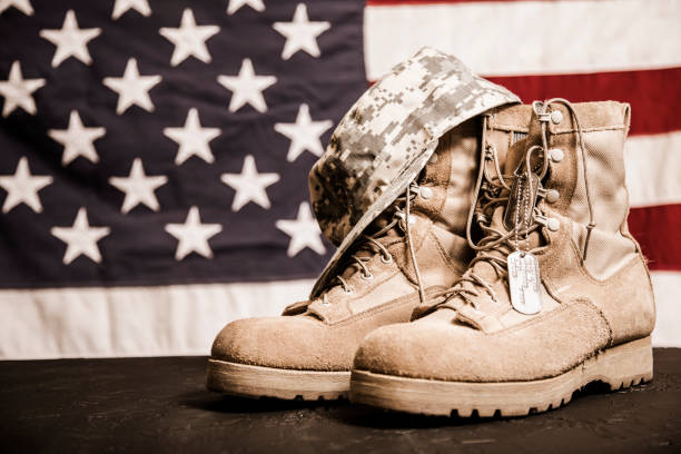 istock USA Military boots, hat and dog tags with flag. 953512530