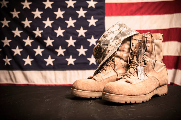 istock USA Military boots, hat and dog tags with flag. 953512928