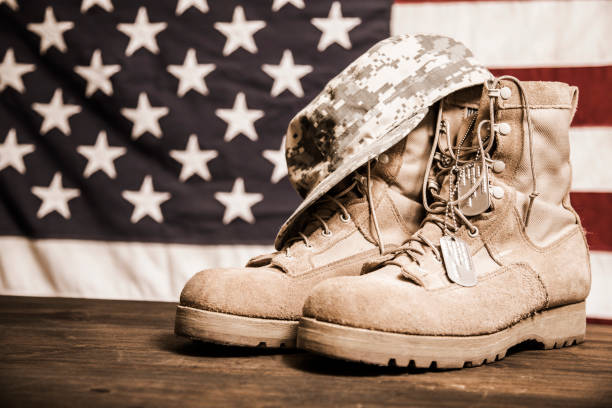 istock USA Military boots, hat and dog tags with flag. 953513124