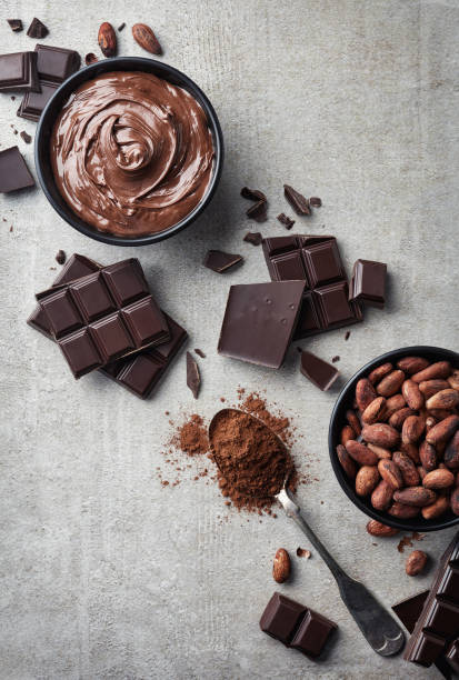 Dark chocolate, cacao powder and beans Dark chocolate, cacao powder and beans on gray marble background. Top view dark chocolate stock pictures, royalty-free photos & images