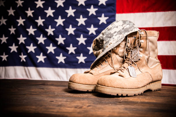 USA Military boots, hat and dog tags with flag. USA military boots, hat and dog tags with American flag in background. No people in this Memorial Day or Veteran's Day image. usa flag shoes stock pictures, royalty-free photos & images