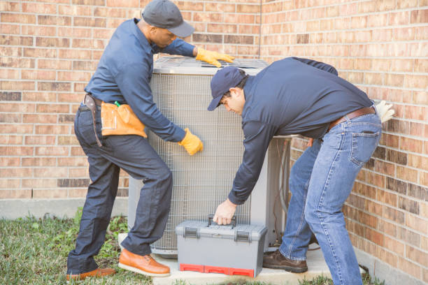 istock Multi-ethnic team of blue collar air conditioner repairmen at work. 953514284