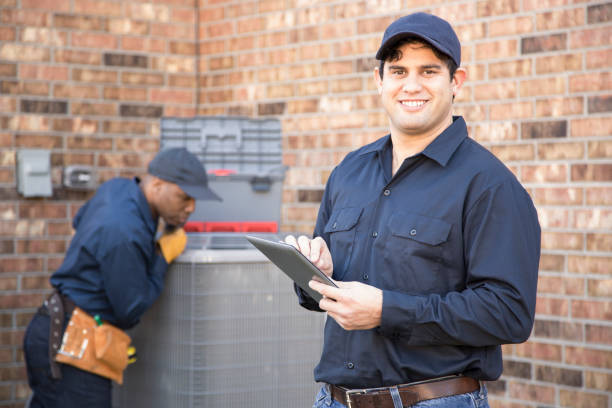 istock Multi-ethnic team of blue collar air conditioner repairmen at work. 953514692