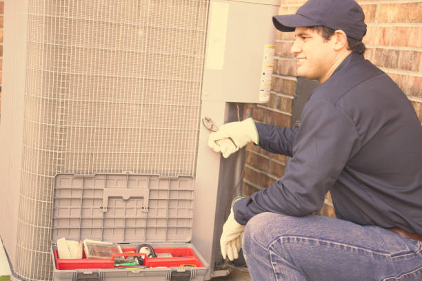 istock Blue collar air conditioner repairman at work. 953514710
