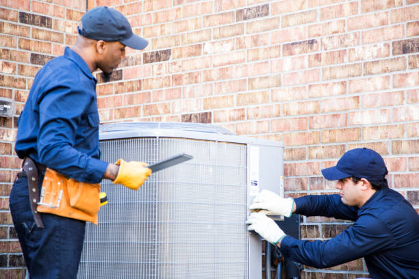 istock Multi-ethnic team of blue collar air conditioner repairmen at work. 953514944