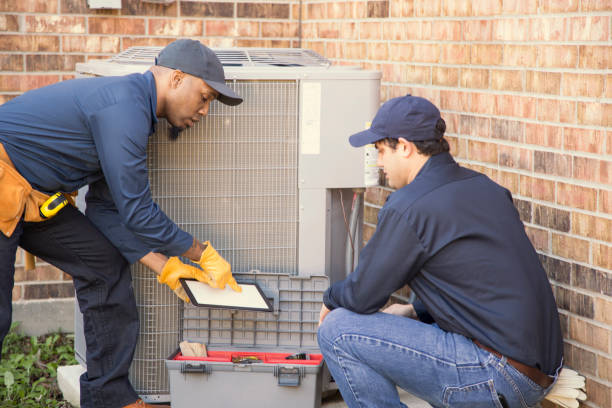 istock Multi-ethnic team of blue collar air conditioner repairmen at work. 953514994