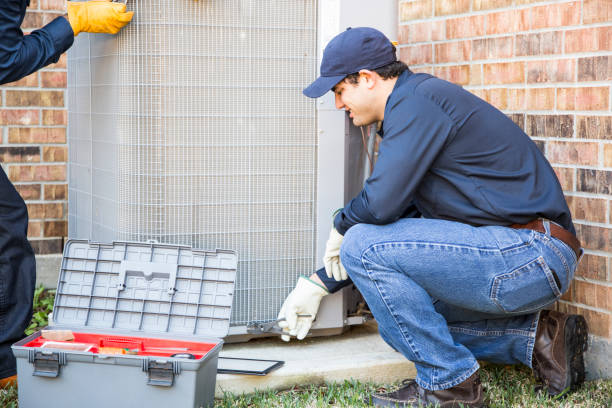 istock Multi-ethnic team of blue collar air conditioner repairmen at work. 953515076