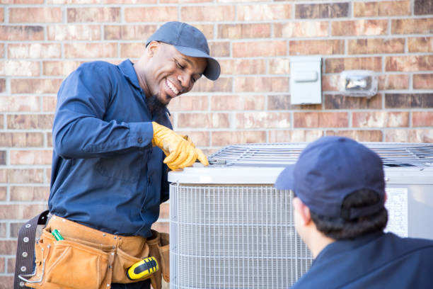 istock Multi-ethnic team of blue collar air conditioner repairmen at work. 953515142