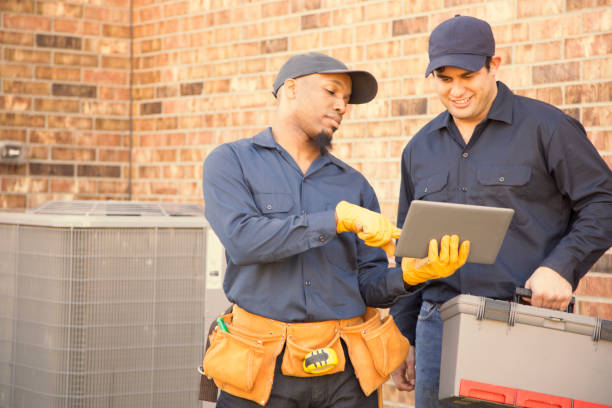 istock Multi-ethnic team of blue collar air conditioner repairmen at work. 953515178