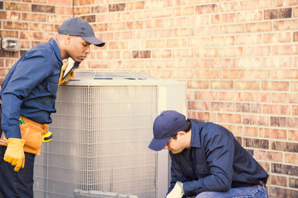 istock Multi-ethnic team of blue collar air conditioner repairmen at work. 953515330