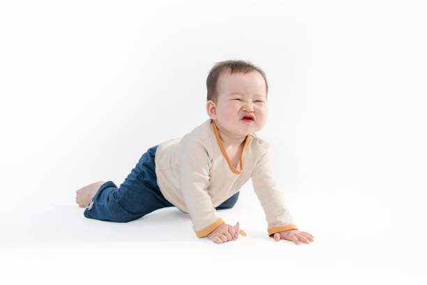 istock Cute baby sitting playing with color models in white background 953516654