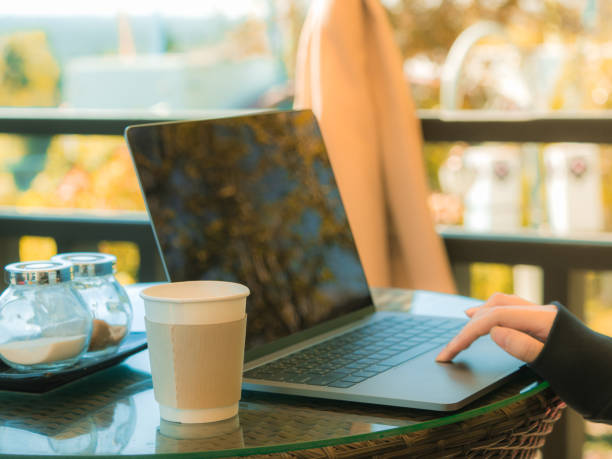 istock business and coffee break concept from freelancer working with computer laptop and drink coffee at outdoor coffee shop in the morning time with soft focus background 953517512